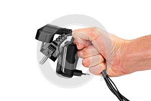 Bundle of disconnected black plugs with cables in hand isolated on white