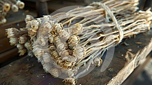 A bundle of dried chrysanthemum buds tied together with a string waiting to be steeped in hot water