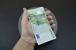 Bundle of hundreds euro in hand