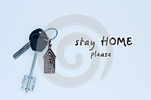 Bundle of keys with a keychai in in the form of a house. Inscription stay home please