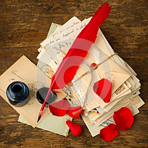 Bundle of letters and red rose petals