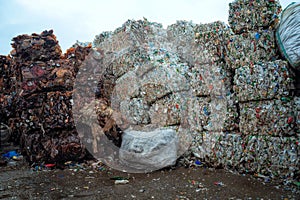 Bundle of pressed plastic bottles prepared for a garbage recycling on waste recycling plant. Camera moves forward