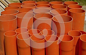 A bundle of red pvc pipes