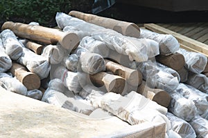 A bundle of smooth wooden logs for building a building.