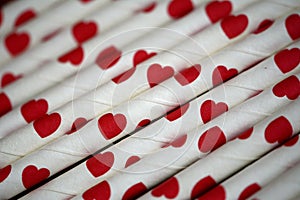 Bundle of straws with printed hearts.