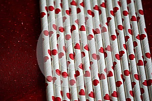 Bundle of straws with printed hearts.