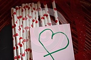 Bundle of straws with printed hearts.