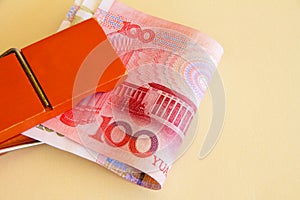 A bundle of Yuan or renminbi notes in an orange clip