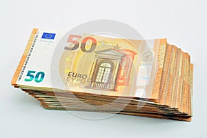 Bundles of 50 euro banknotes, isolated on white
