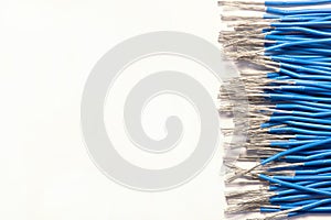 Bundles of blue electrical wires without insulation. white background, close-up