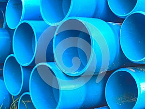 Bundles of blue plastic pipes for water transport. Pipe batch