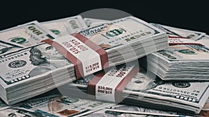 Bundles of Dollars Lying on a Pile of Money and Rotate on Black Background