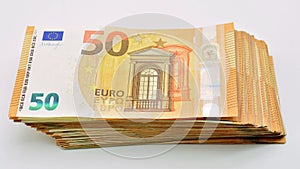 Bundles of 50 euro banknotes, isolated on white photo