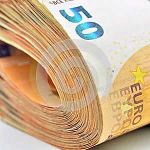 Bundles of 50 euro banknotes, isolated on white photo