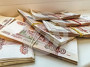 Bundles of five-thousand-dollar bills lie in a fan. Banknotes with a face value of 5000 rubles.