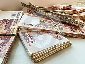 Bundles of five-thousand-dollar bills lie in a fan. Banknotes with a face value of 5000 rubles.