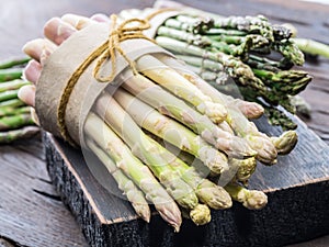 Bundles of green and white asparagus on wooden board. Organic food.