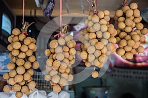 Bundles of longan hang over the counter merchant Singapore