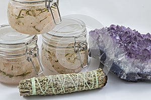Bundles of Sage with amethyst and jars of beauty product