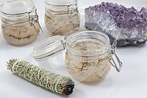 Bundles of Sage with amethyst and jars of beauty product