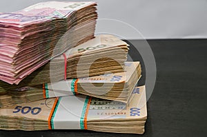 Bundles of Ukrainian money, stacks of hryvnia, 200,500. money concept. Lots of banknotes. Black background