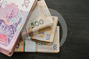 Bundles of Ukrainian money, stacks of hryvnia, 200,500. money concept. Lots of banknotes. Black background. Close-up. View from ab