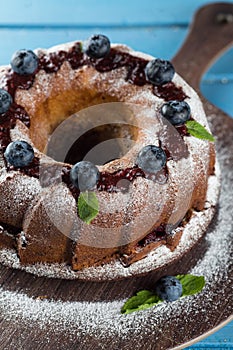 Bundt cake with icing sugar and blueberry