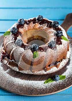 Bundt cake with icing sugar and blueberry