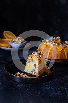 Bundt cake, orange cake with walnuts and yellow sugar icing with turmeric spice.