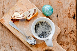 Bundt easter marble cake, blue easter egg and cup of coffee