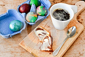 Bundt easter marble cake, blue easter egg and cup of coffee