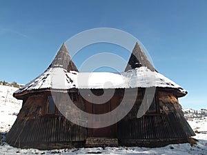 The Bungalow built in a traditional way with the snow covered roof photo