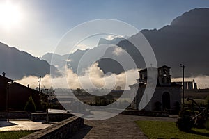 Bungalow Resort with a small chapel in morning fog