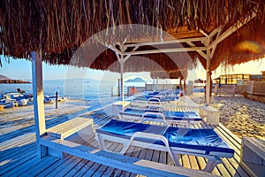 Bungalow on the sea at sunset. Wooden pavilions on the shore of a sandy beach - Bodrum, Turkey