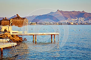 Bungalow on the sea at sunset. Wooden pavilions on the shore of a sandy beach - Bodrum, Turkey