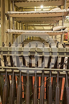 Bunk beds and rifles in WWII Liberty Ship troop transport