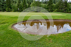 Bunker full of water on a golf course