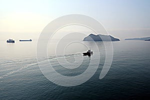 Bunkering of a ship on the open roadstead of the port of Nakhodka, Russia.