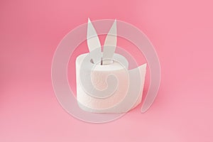 Bunny ears out of white toilet paper roll on pastel lifht pink background. Easter funny trendy rabbit concept. Side view