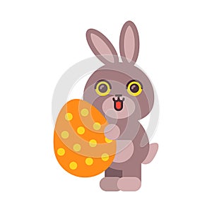 Bunny holding egg and smiling. Funny character