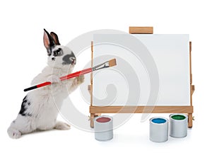 Bunny stand at easel with tassels isolated on a white background. for writing your text