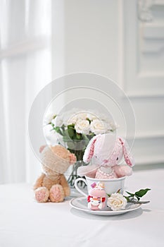 Bunny and teddy. Cute stuffed animals of pink rabbit doll and brown teddy bear sitting together. Love and friendship concept. Soft