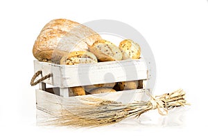 Buns and ciabatta, bread on wooden box. Barley and fresh mixed breads isolated on white background.