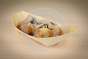 Buns with plum filling and with cottage cheese on wooden table