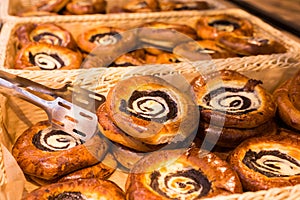 Buns with poppy seed curd filling in baskets in bakery