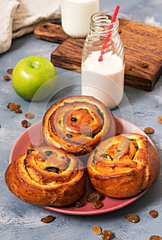 Buns with raisins and milk. Breakfast with fresh pastries.