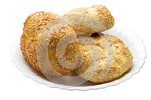 Buns with sesame on a white plate