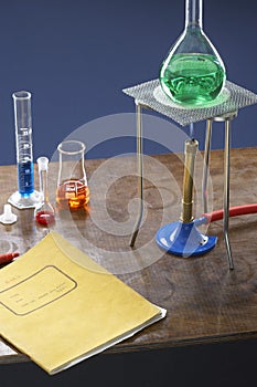 Bunsen burner tripod flask and test tubes in science laboratory