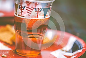 Bunting covered beer glass and plate at the afternoon picnic at Garth Park, Bicester