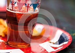 Bunting covered beer glass and plate at the afternoon picnic at Garth Park, Bicester